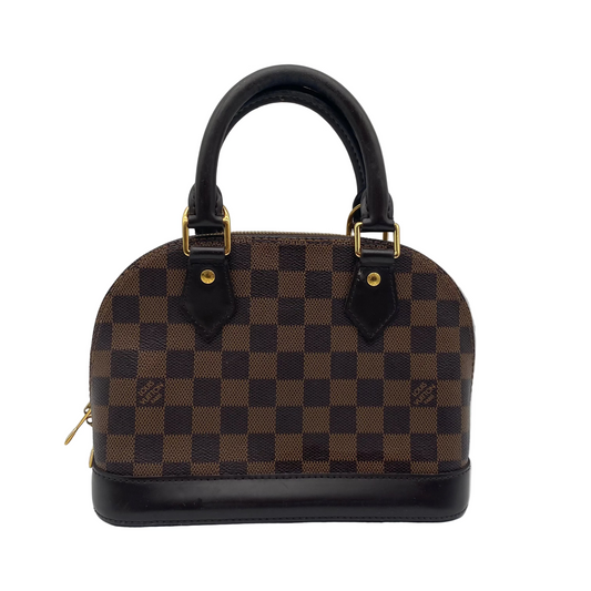 A Louis Vuitton Damier Azur dome handbag with brown and black checkered canvas, black leather handles and trim, and gold-tone hardware, photographed against a light gray background.